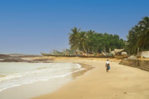 Lady walking along Ampenyi beach